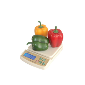 An electric compact scale with peppers on top.
