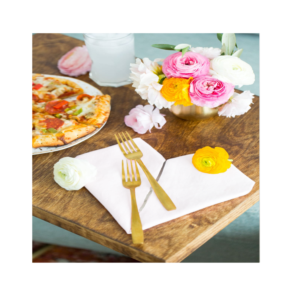 Plain napkins on a table with pizza.
