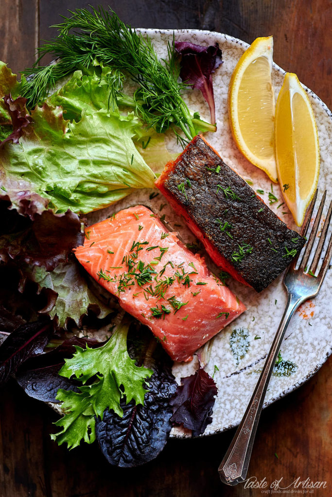 Salmon sous vide with lemon and lettuce.