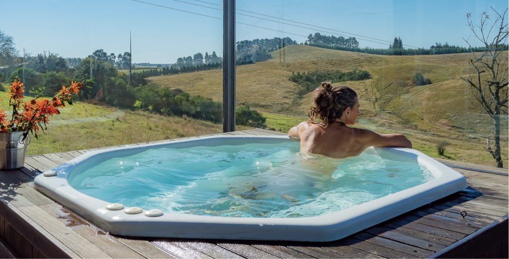 Woman in a jacuzzi looking at the Midlands view at Brahman Hills.