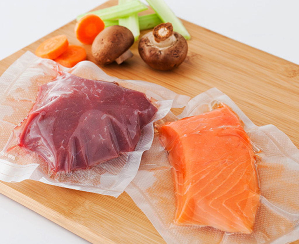 Fish and meat getting in vacuum-sealed bags.