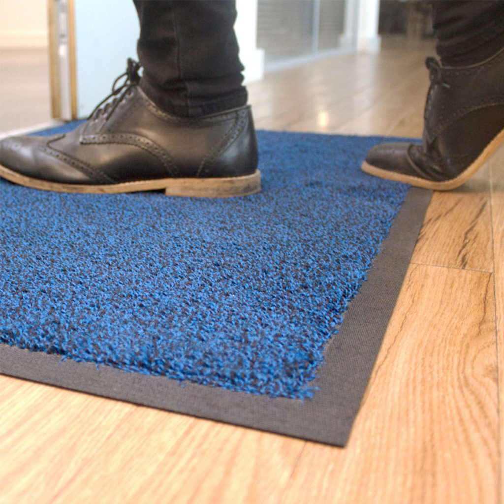 A Coba Africa CobaWash floormat in blue, in use.