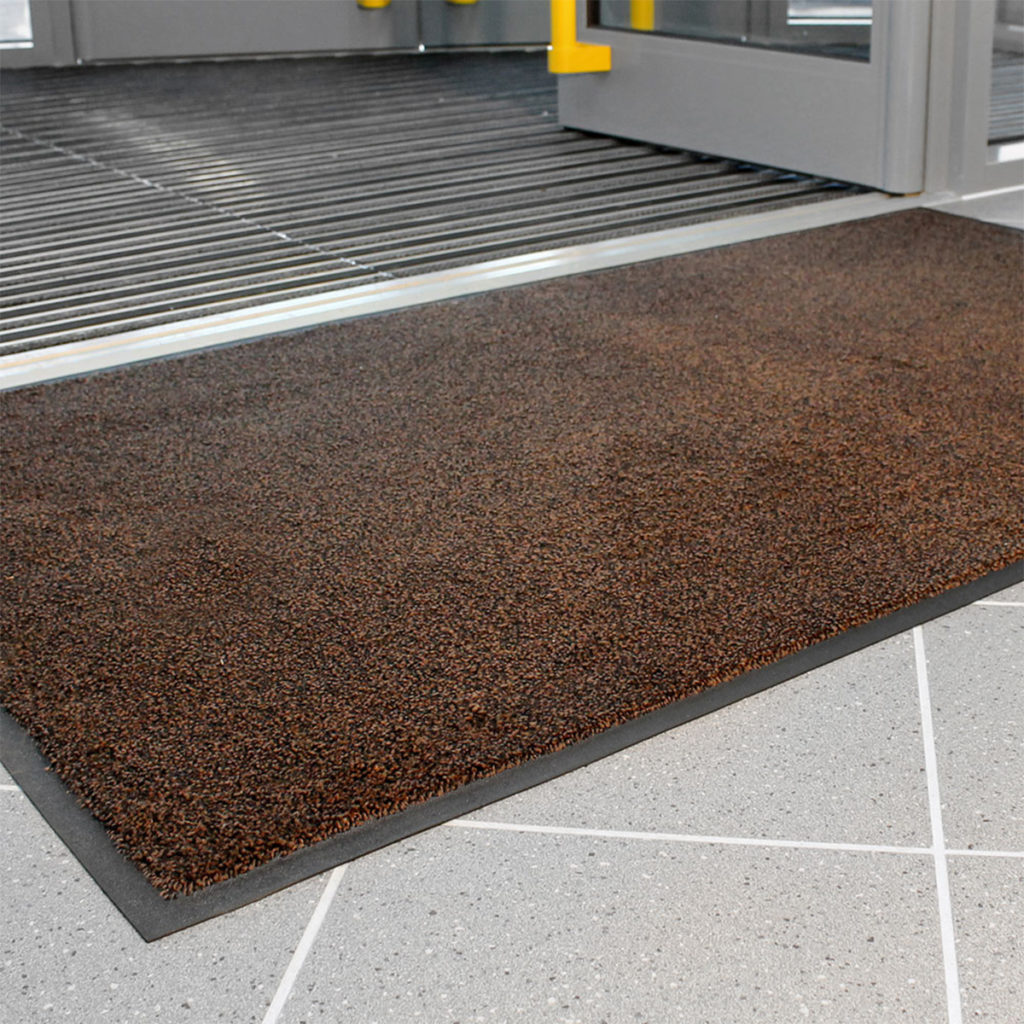 A Coba Africa CobaWash floormat in brown, in use.