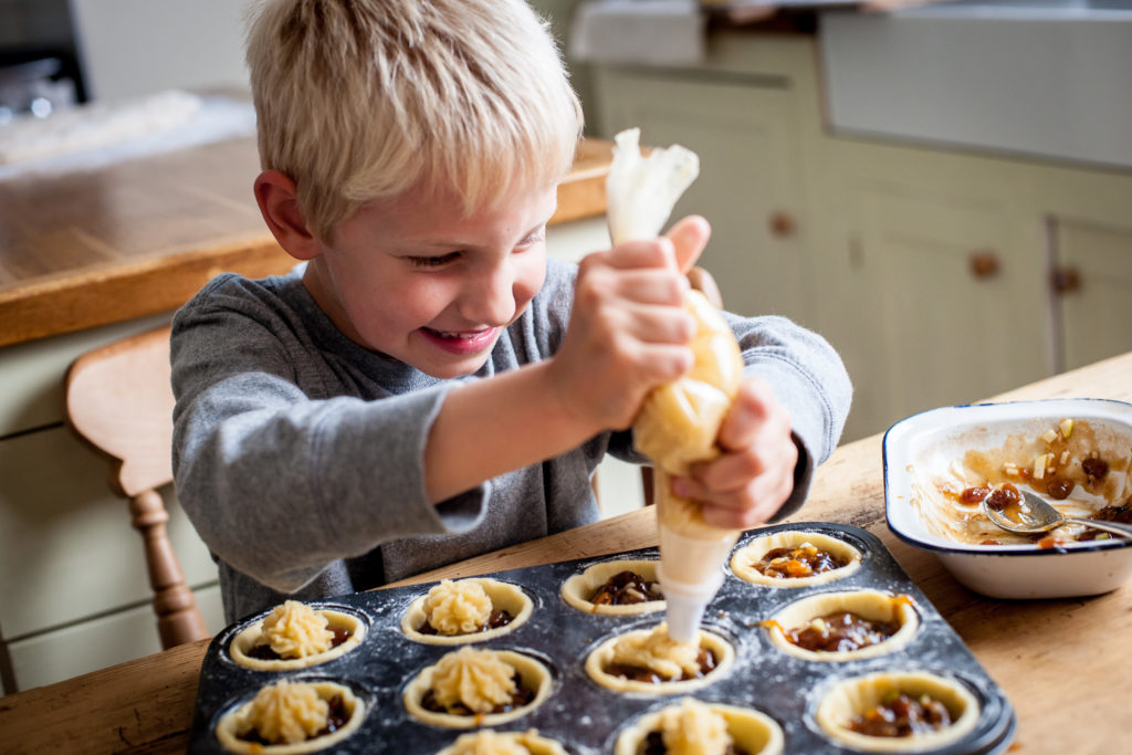 A kid making minced pies.